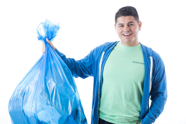 istock Confident man picks up trash in his community 909258214