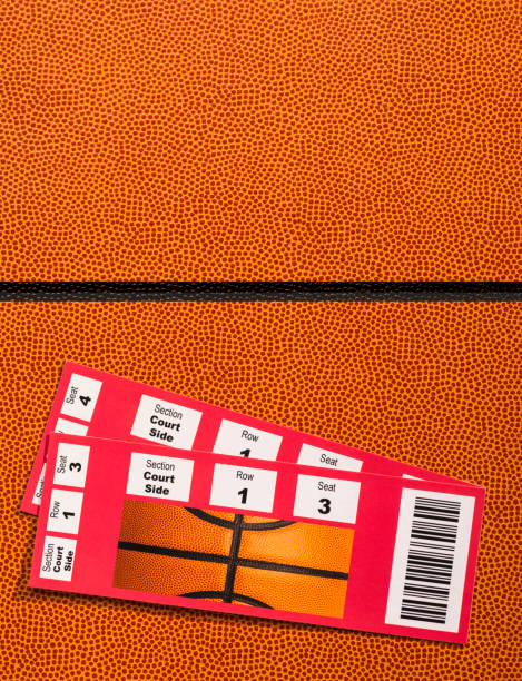 istock Ticket stubs sitting on Basketball textured background 909258236