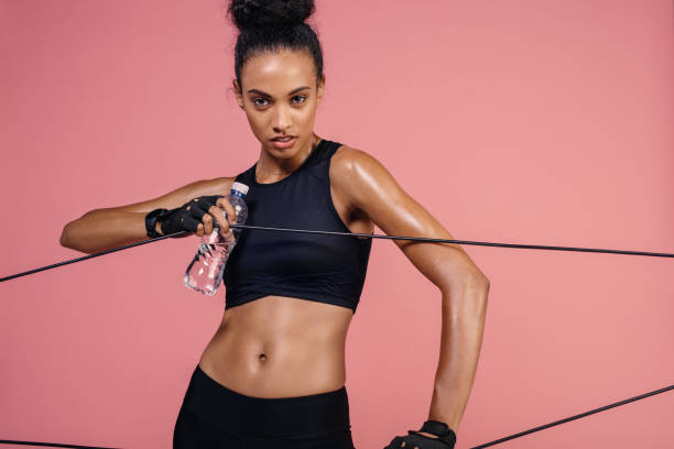 istock Strong woman exercising with elastic band 909262576