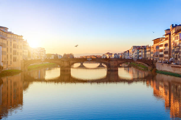 The medieval bridge Carriya on the Arno River, sunset landscape. View of the Arno River from the seafront in Florence.The medieval bridge Carriya on the Arno River, sunset landscape. View of the Arno River from the seafront in Florence.