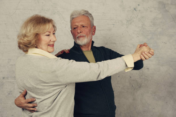 istock Happy stylish elderly couple dancing and laughing. Vintage image 909267434