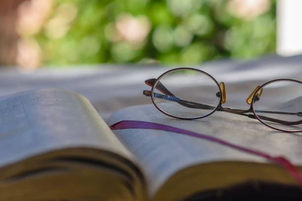 istock Close view glasses on bible 909272438