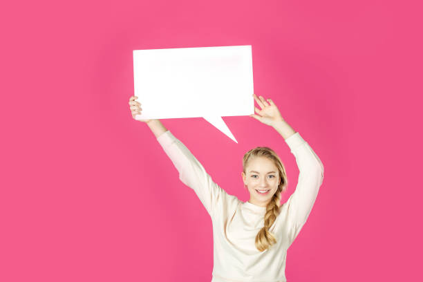 istock girl holding speech bubble 909272476