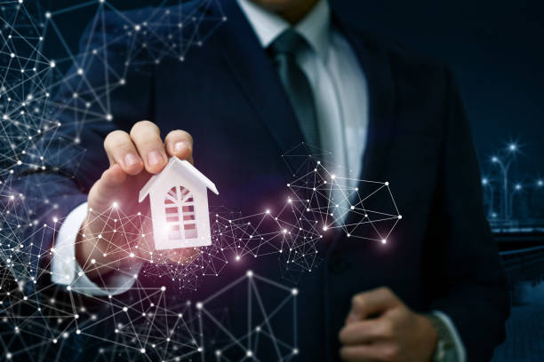 istock A businessman shows a model of a house . 909276452