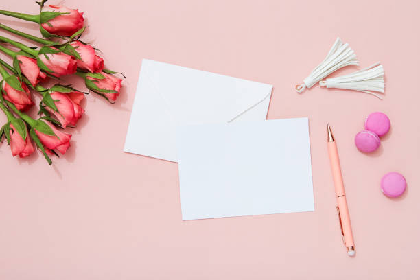 istock Greeting card, pen and roses on pink background 909279656