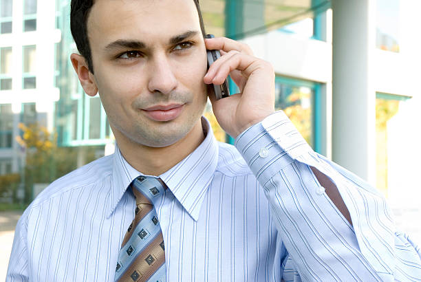 istock young  businessman on a cellphone 90928296