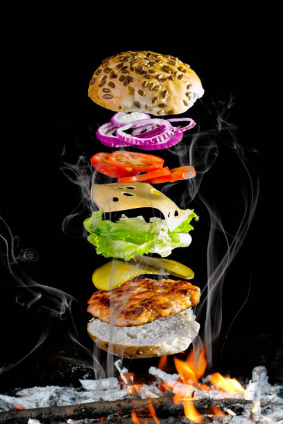 istock fresh tasty burger's on black background 909283618