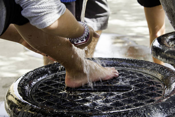 Washing feet in fountain after harvesting, hygiene and cleaning