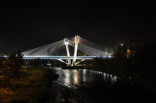 Lleida, Spain - October 28, 2010: Beautiful modern bridge with illumination across the river Segre of Lleida city. Spain