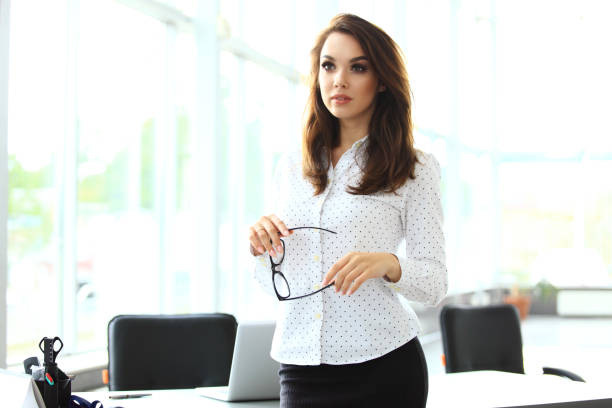 istock Modern business woman in the office with copy space. 909287052