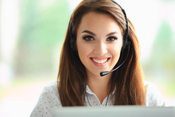 istock Portrait of happy smiling female customer support phone operator at workplace. 909288242