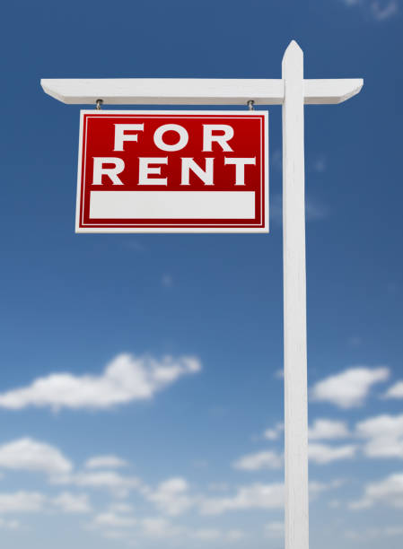istock Left Facing For Rent Real Estate Sign on a Blue Sky with Clouds. 909291196