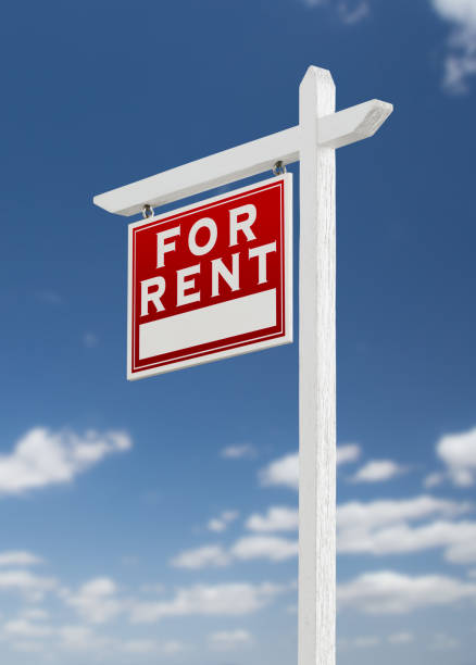 istock Left Facing For Rent Real Estate Sign on a Blue Sky with Clouds. 909291212