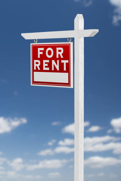 istock Left Facing For Rent Real Estate Sign on a Blue Sky with Clouds. 909291294