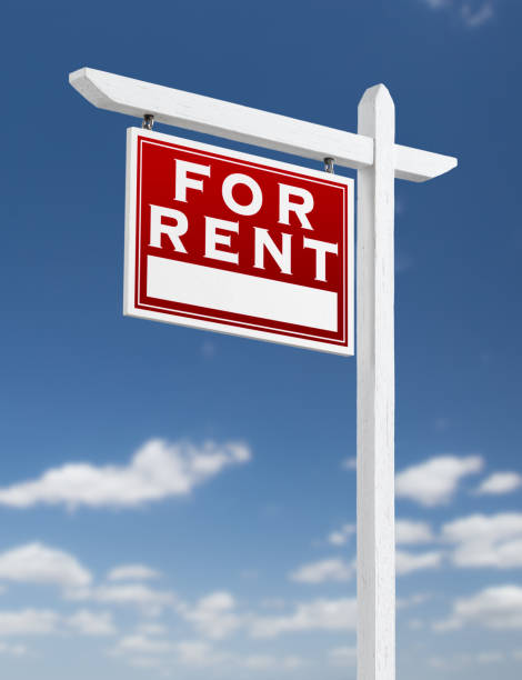istock Left Facing For Rent Real Estate Sign on a Blue Sky with Clouds. 909291376