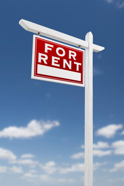 istock Left Facing For Rent Real Estate Sign on a Blue Sky with Clouds. 909291438