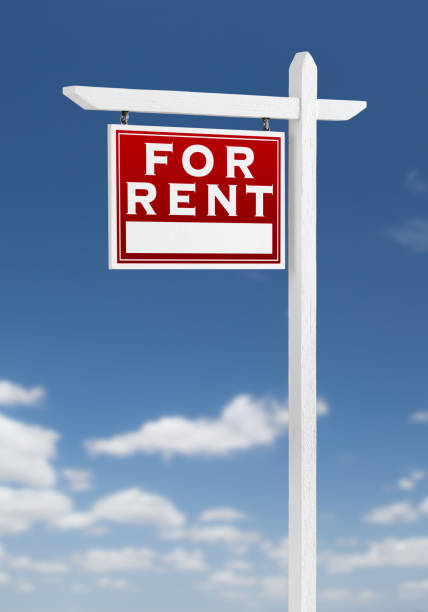 istock Left Facing For Rent Real Estate Sign on a Blue Sky with Clouds. 909291468