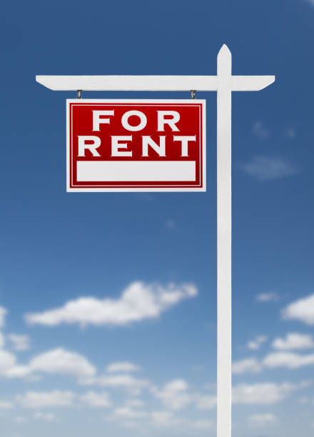 istock Left Facing For Rent Real Estate Sign on a Blue Sky with Clouds. 909291492