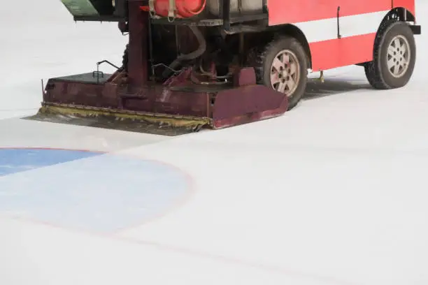 Resurfacer levels ice at hockey rink, special machine