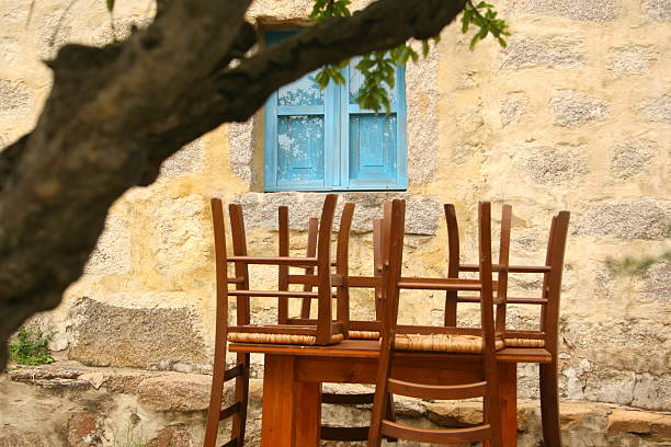 miniature greek style table and chairs with the beautiful lonesome beach in the background and copy space