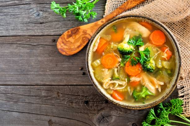 istock Homemade chicken vegetable soup, above view on rustic wood 909299482