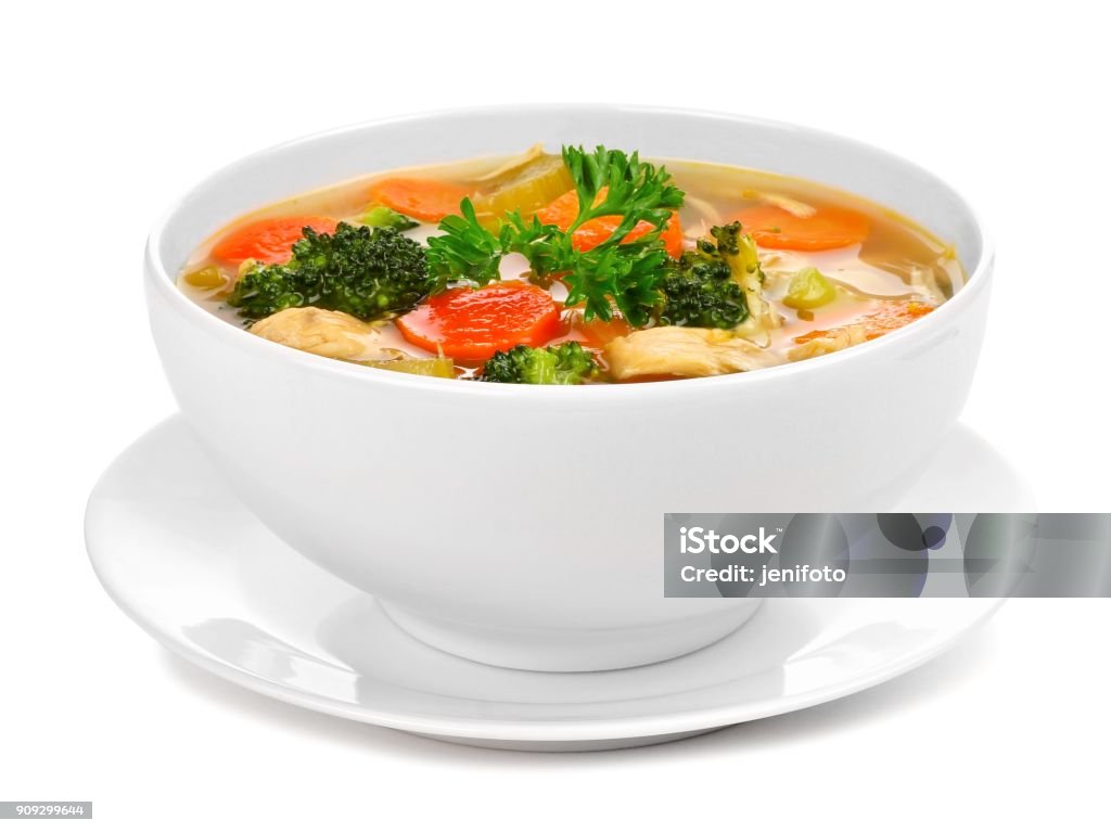 Homemade chicken vegetable soup isolated on white Homemade chicken vegetable soup in a white bowl with saucer. Side view isolated on a white background. Soup Stock Photo