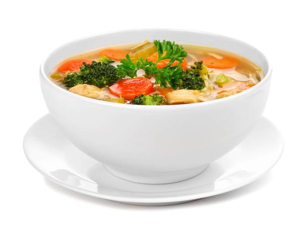 Homemade chicken vegetable soup isolated on white Homemade chicken vegetable soup in a white bowl with saucer. Side view isolated on a white background. cut out bowl of soup stock pictures, royalty-free photos & images