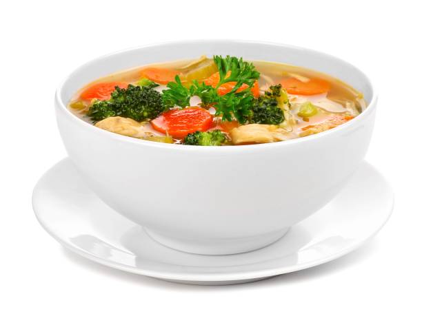 Homemade chicken vegetable soup isolated on white Homemade chicken vegetable soup in a white bowl with saucer. Side view isolated on a white background. soup stock pictures, royalty-free photos & images