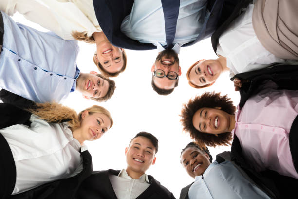 istock Happy Businesspeople Forming Huddle 909303470