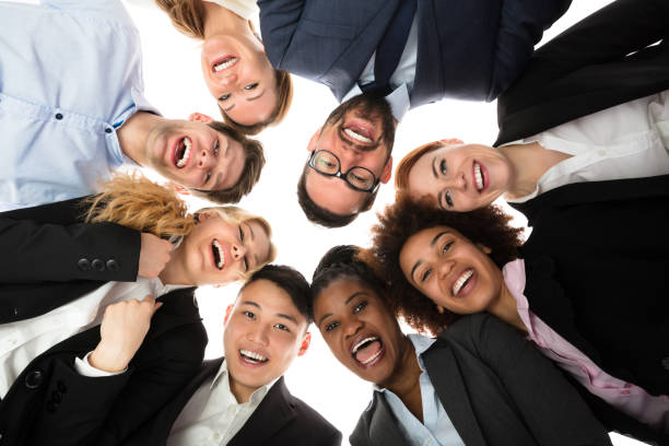 istock Smiling Businesspeople Standing Against White Background 909303488