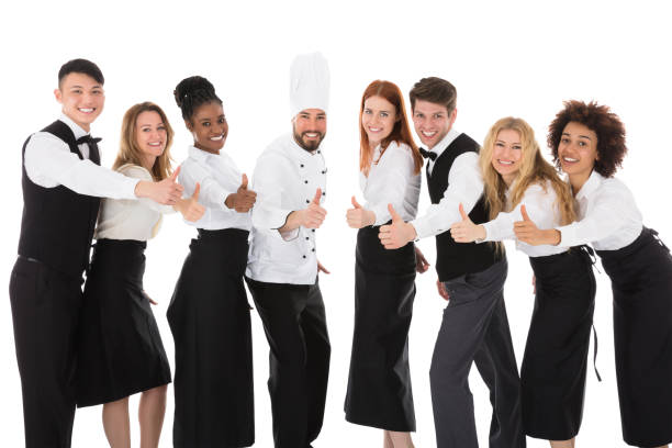 istock Smiling Restaurant Staff Gesturing Thumbs Up 909303558