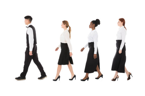 istock Young Restaurant Staff Walking In Row 909303572