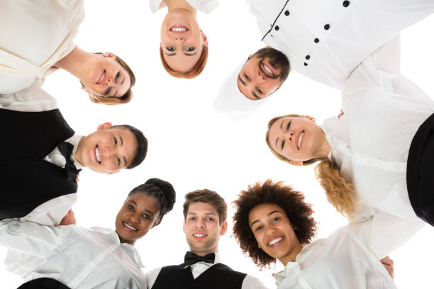 istock Happy Restaurant Staff Forming Huddle 909303578