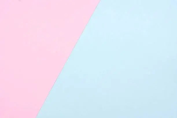 Pastel pink and blue paper texture abstract background. Off center, angle.