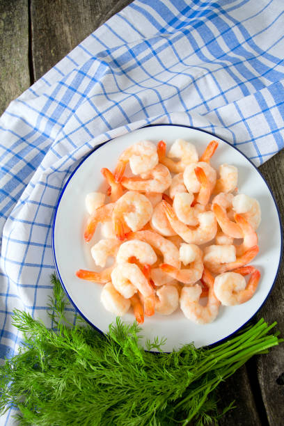 istock frozen shrimps on wooden surface 909306416
