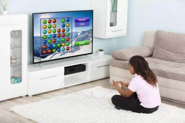 istock Girl Playing Video Games At Home 909307178