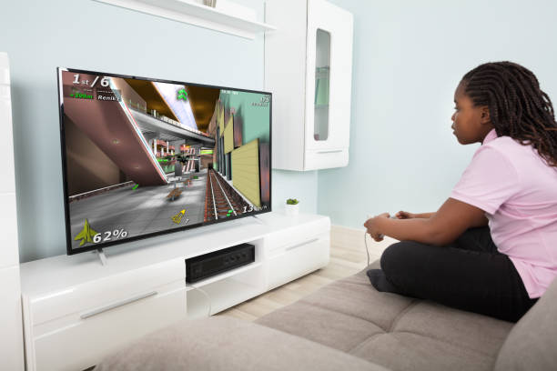 istock Girl Playing Video Game With Joysticks 909307192