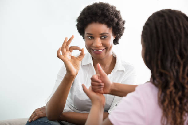 istock Deaf Mother Talking Sign Language With Her Daughter 909307226