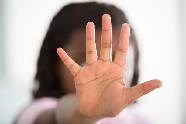 istock Girl Showing Stop Sign 909307320