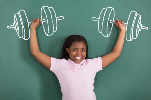 istock Smiling Girl Imaging Weightlifting 909307326