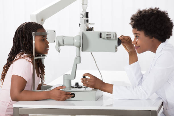 istock Female Optometrist Examining Patient 909309816