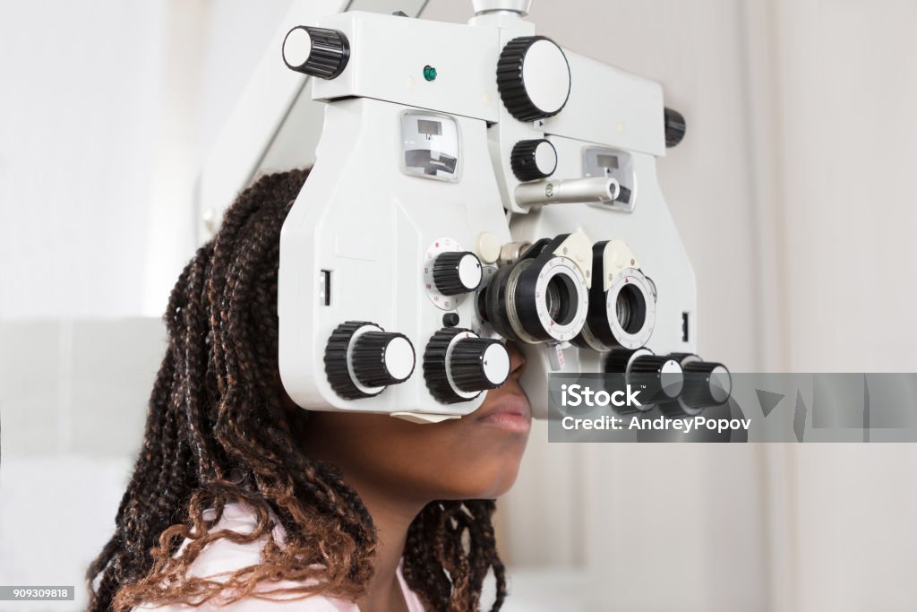 Girl Doing Eye Test Close-up Of A Girl Doing Eye Test On Phoropter Eye Exam Stock Photo