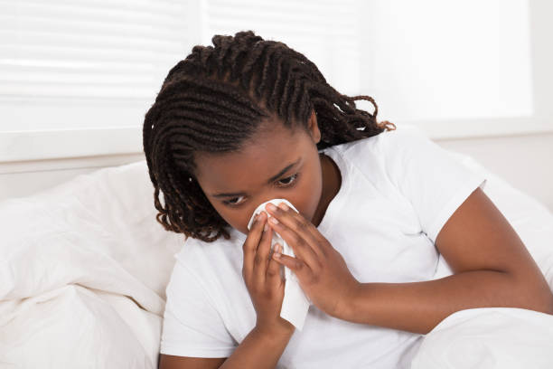 istock Girl Blowing Her Nose With Tissue 909310040
