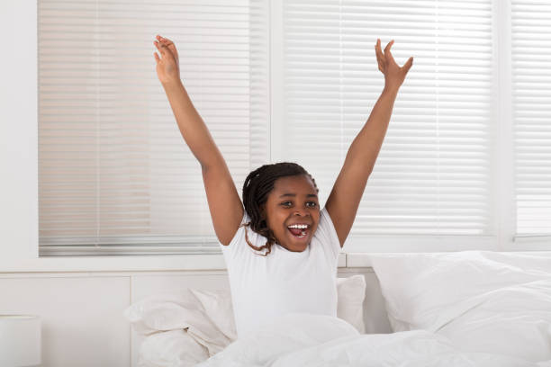 istock Happy Girl Waking Up 909310062