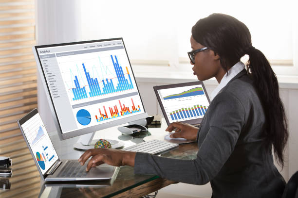 istock Businesswoman Looking At Graphs On Computer 909310466