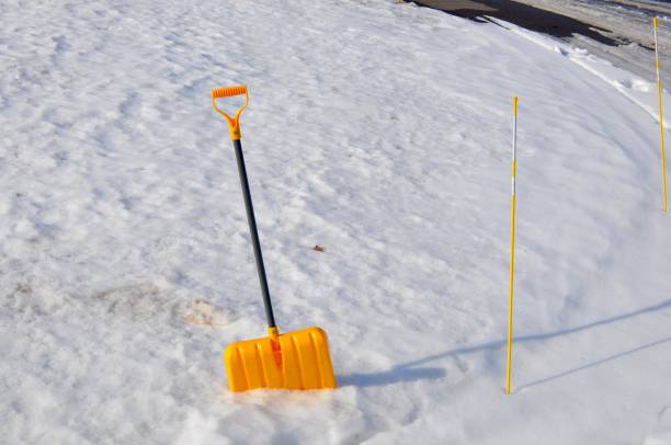 Winter white snow with yellow snow shovel.