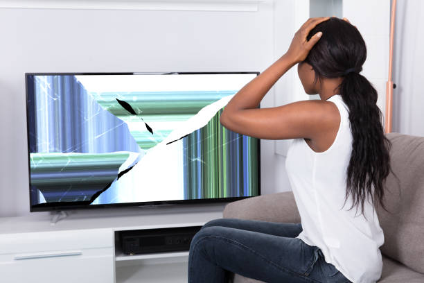 istock Upset Woman Looking At Broken Television Screen 909313554
