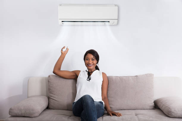 istock Woman Using Air Conditioner At Home 909313574