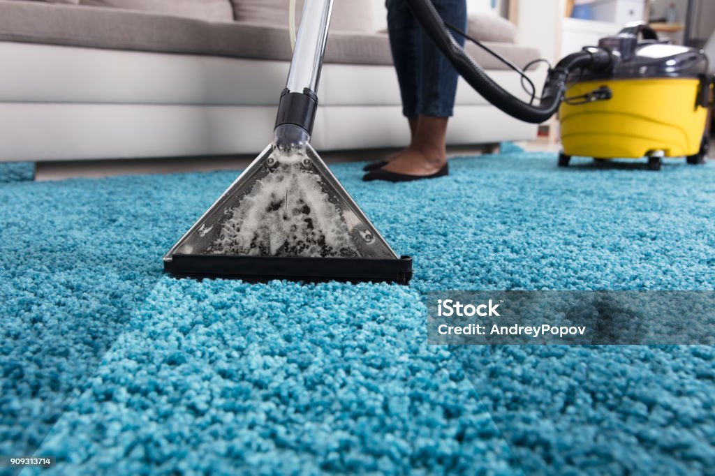 Person Using Vacuum Cleaner For Cleaning Carpet Person Using Vacuum Cleaner For Cleaning Blue Carpet At Home Rug Stock Photo