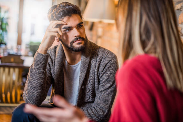 Young man listening to his girlfriend about her problems.